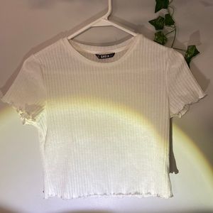 A all white shirt sleeve crop top.